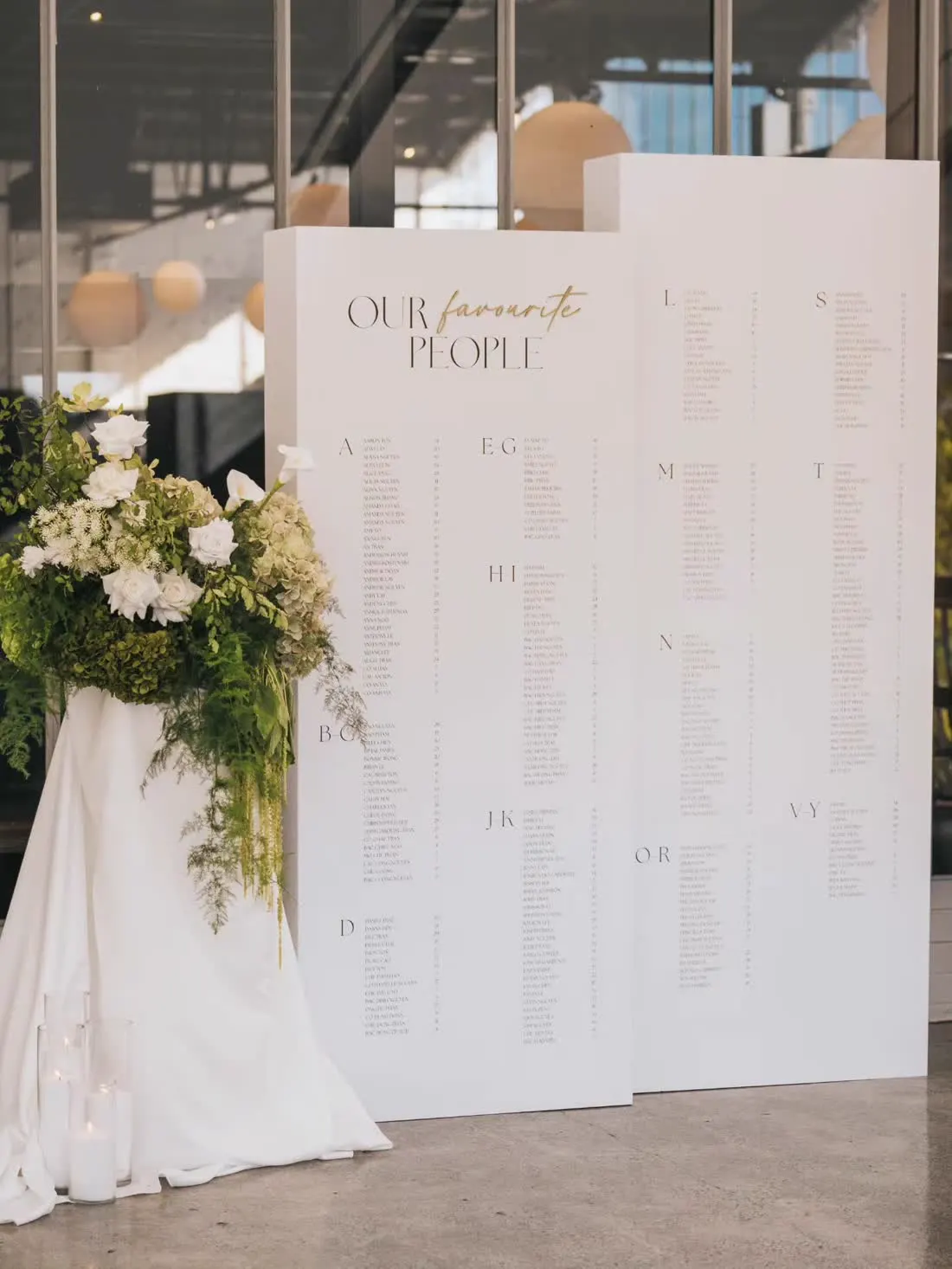 White seating chart panels styled with florals