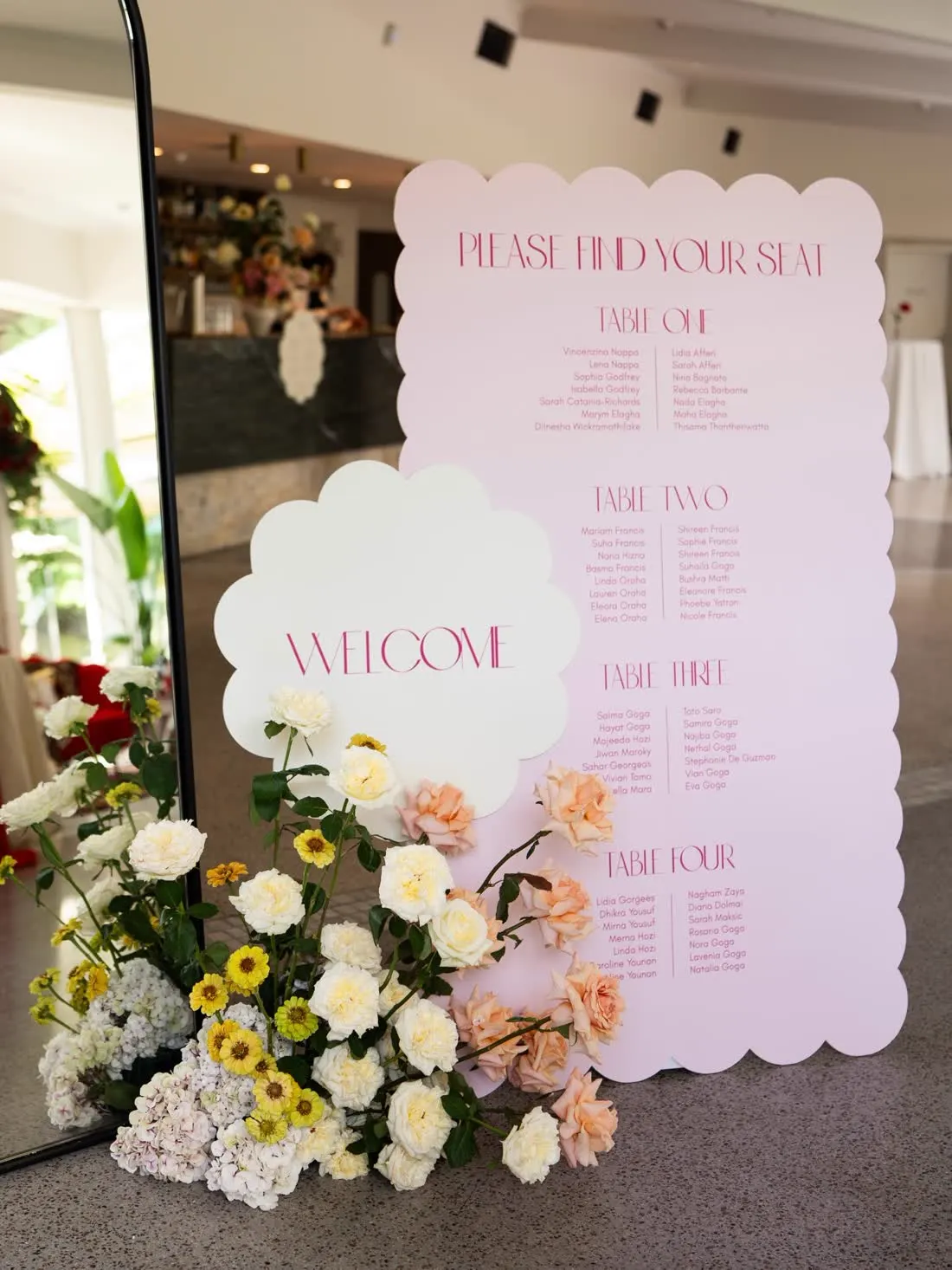 Scalloped pink wedding seating chart and welcome sign